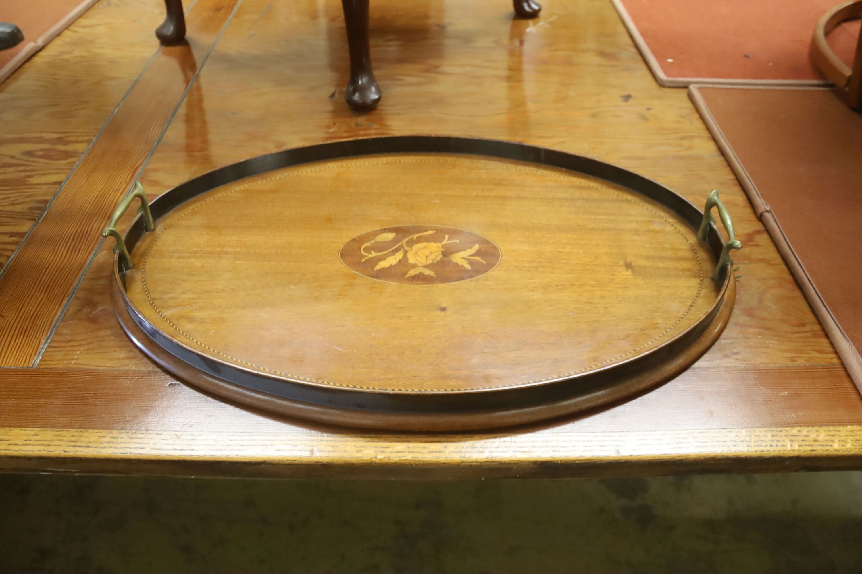 A Victorian walnut circular tripod table (a.f.) and an Edwardian inlaid oval tea tray